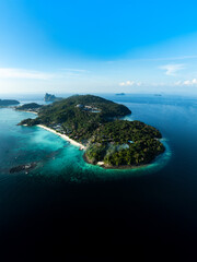 Top-down aerial shot of Phi Phi Don island, showcasing tropical beaches, lush vegetation, and clear turquoise waters in southern Thailand.