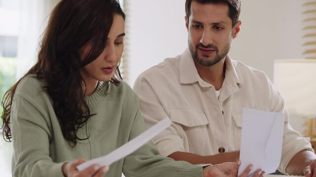 Couple facing overdue bills and financial pressure at home, stressed by inflation and economy recession