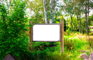 Wooden advertising or information billboard in the forest path. Mock up Wood board inside the...