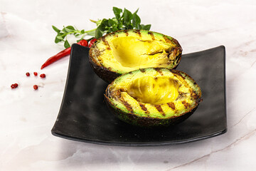 Sliced fresh avocado on the grill