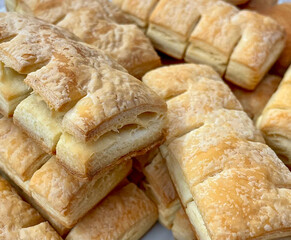 Freshly baked pastry squares stacked on a plate.