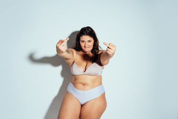 Obraz premium Plus size woman posing in studio in lingerie