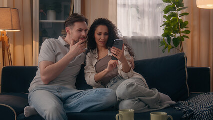 Multiracial happy couple family Caucasian man guy male Hispanic woman girl female talking using...
