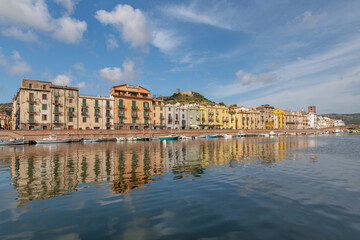 View of the old town of Bosa, colorful houses reflecting in the Temo river, the bridge and the castle, Sardinia island, Italy.