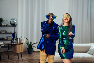 Naklejka premium cinematic image of an happy multiethnic senior couple. Indoors Lifestyle moments at home. Concept about seniority and relationships