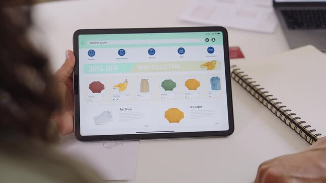 Couple using tablet and credit card to shop online through e-commerce app, making payment and browsing modern platform with promo codes and discount offers