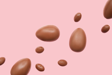 Tasty chocolate eggs flying on pink background