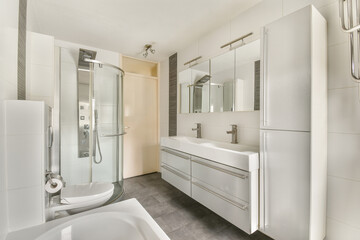 A sleek and modern bathroom design featuring a glass shower, dual sinks, and contemporary fixtures. The clean lines and neutral colors create a calming atmosphere.