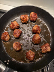 Delicious meatballs on the frying pan.