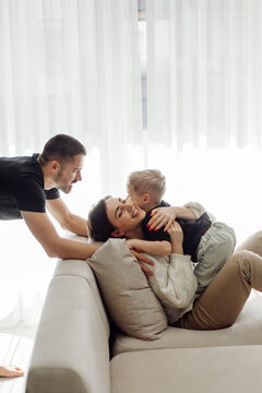 Happy family playing and having fun on sofa at home