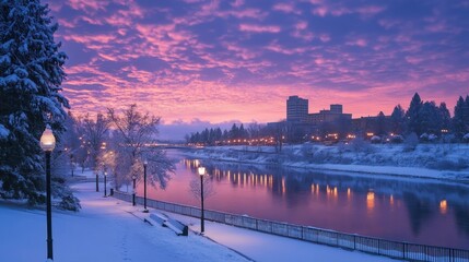 Fototapeta premium Snowy city sunrise reflected in calm river.