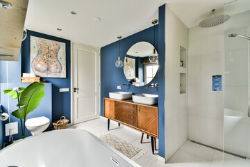 A visually appealing modern bathroom featuring stylish fixtures, decorative elements, and a serene atmosphere enhanced by plants and art.
