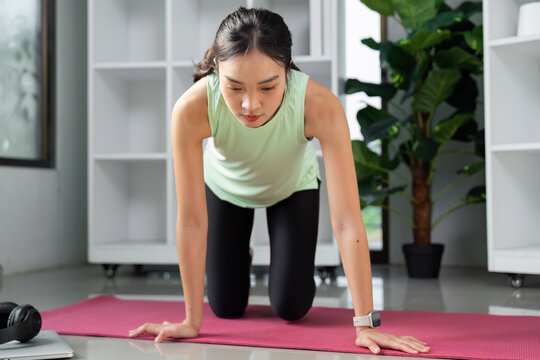 Strength and Mobility. A woman practicing yoga on all fours, focusing on core strength and stability.
