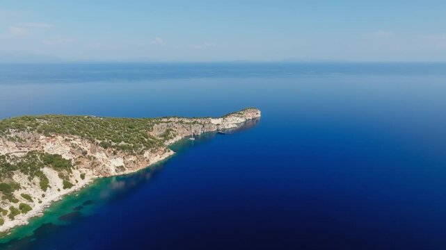 Top down aerial of clear waters and rocky coastline at Hulla Beach, Ithaca Island