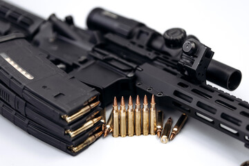 Close-up of assault rifle, ammunition and 7.62 caliber ammunition magazine on isolated light...