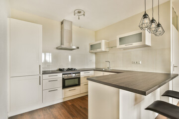 A sleek and stylish modern kitchen featuring contemporary cabinetry, a central island, and sophisticated appliances, ideal for cooking and entertaining.
