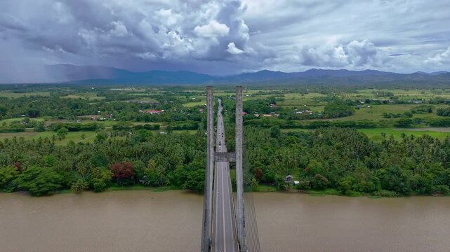 Aerial flypast glides over the Macapagal Bridge bypassing Butuan City as it spans the Agusan River in Mindanao, Philippines.