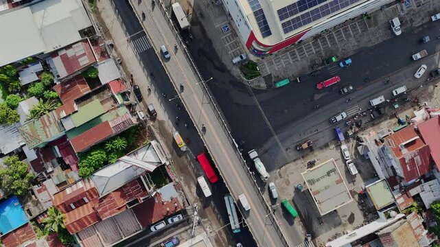 Top-down aerial shot over a busy highway junction and flyover in Cagayan de Oro, Mindanao, Philippines, illustrating heavy commuter traffic and road infrastructure.