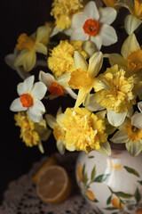 Still-life. Photo of a bouquet of daffodils with lemons.