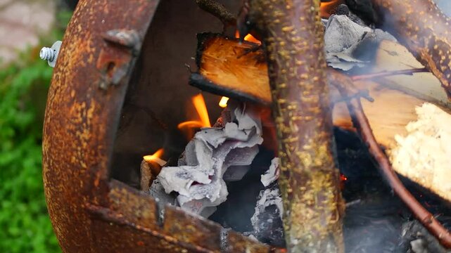 burning wood and paper. firewood is burning. tongues of flame. orange flame. bonfire. wood-fired cooking. firewood is burning for cooking barbecue