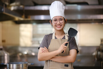 Portrait young teen girl cook student. Cooking class. Culinary classroom. Happy young woman students for cooking in cooking school.