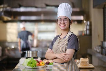Portrait young teen girl cook student. Cooking class. Culinary classroom. Happy young woman...