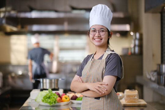 Portrait young teen girl cook student. Cooking class. Culinary classroom. Happy young woman students for cooking in cooking school.