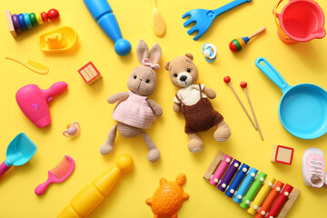 Composition with different toys on yellow background