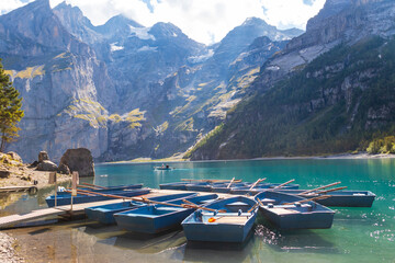 Anchored boats on the Oeschinen lake (Oeschinensee) near Kandersteg in Bernese Oberland, Switzerland © olyasolod