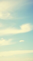 Obraz premium Serene blue sky with soft white clouds on a tranquil day