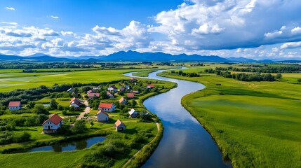 Obraz premium Idyllic River Village, Green Fields, Mountains - Aerial Views: Dro.