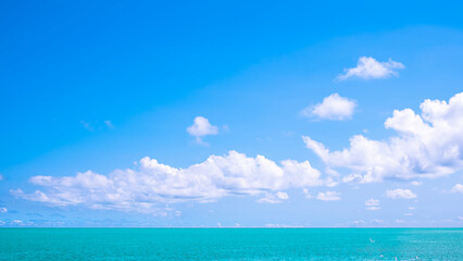 Blue sky background with clouds over sea, Summer Nature seascape horizon view with copy space