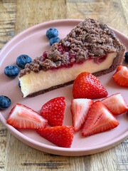 Tasty cheesecake crumble with berries on a plate