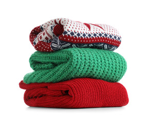 Stack of clean sweaters isolated on white background