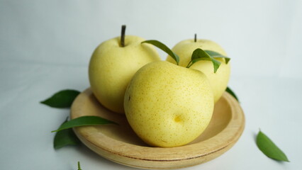 pears on a wooden tray white background