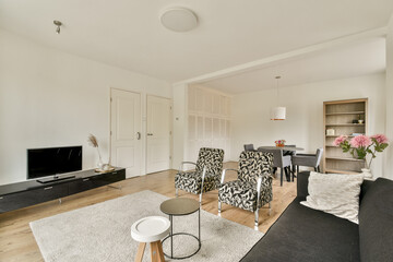 A stylish modern living room featuring elegant furniture, a cozy ambiance, and a blend of functionality and aesthetics that makes it inviting and chic.