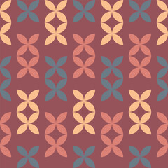 Colorful geometric pattern featuring interconnected leaves on a warm background ideal for textile design