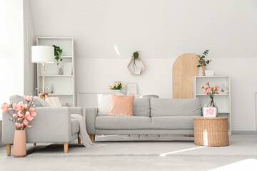 Interior of living room decorated for Mother's Day with sofas and flowers