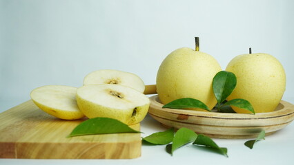pears on a wooden tray white background