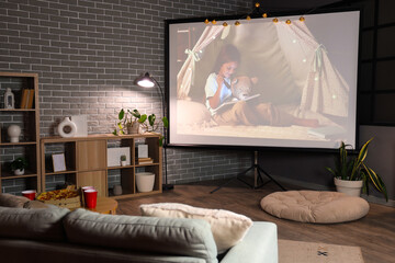 Interior of dark room with video projector screen. Home cinema