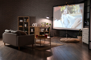 Interior of dark room with video projector screen. Home cinema