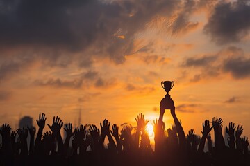 Crowd celebrating trophy at sunset