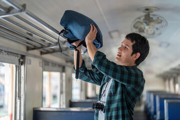 Preparation and Journey. A young traveler organizing his backpack inside a train.