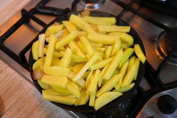 fried potatoes in a pan. Frying fresh potatoes in a frying pan with sunflower oil. Fried potatoes...