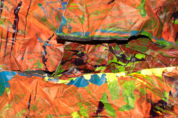 Thick abstract paint surface with heavy texture looking a bit like graffiti hand drawn real orange background