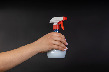 Water sprayer bottle in hand. household items for home