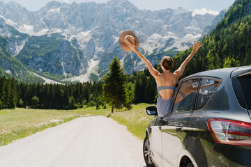 Happy beautiful woman traveling by car in mountains. Travel nature outdoors
