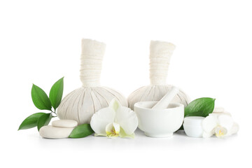 Spa composition with massage bags, sea salt and orchid flowers on white background
