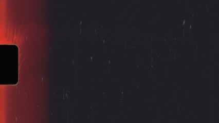 Super 8 film burn effect showing red light leaks and film grain on black background