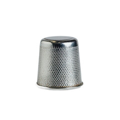 A small, round, textured, metallic thimble for protecting the finger while sewing.